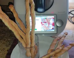 Step <p>Con un rodillo, extienda la masa sobre la superficie de trabajo espolvoreada con harina hasta obtener un rectángulo de aprox. 20x40 cm. Con un cuchillo largo y afilado, corte tiras de 1 cm. Coja cada tira por los extremos, gírelas en sentidos opuestos y colóquelas en la bandeja preparada.</p><p><br></p><p>-Deje reposar durante aprox.15 minutos.Hornee los colines durante 20 minutos (200°C). Retire del horno, deje enfriar y listo!!!!</p> illustration